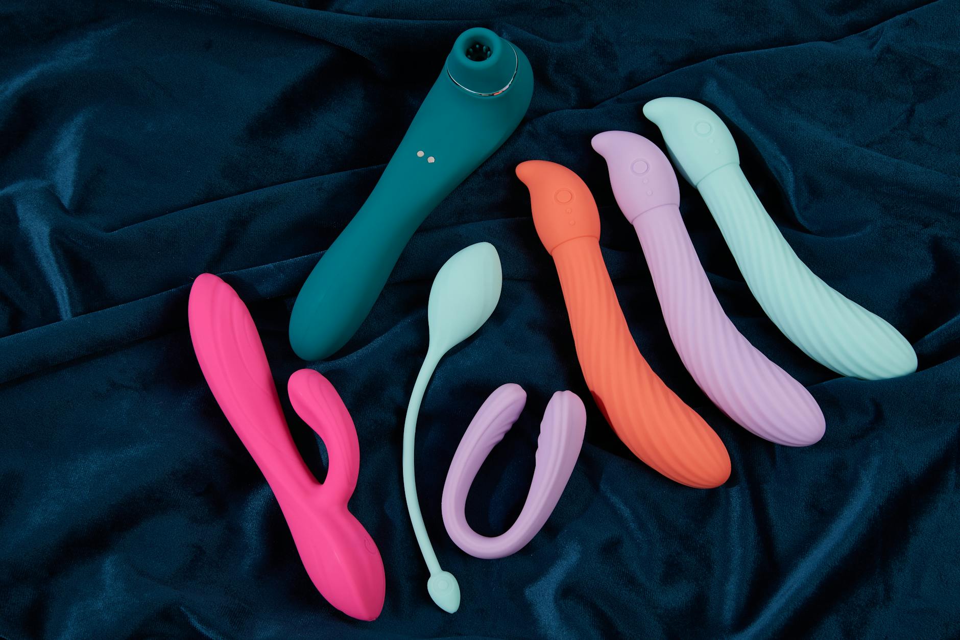 A couple standing together holding a blue vibrator, symbolizing modern intimacy and connection.