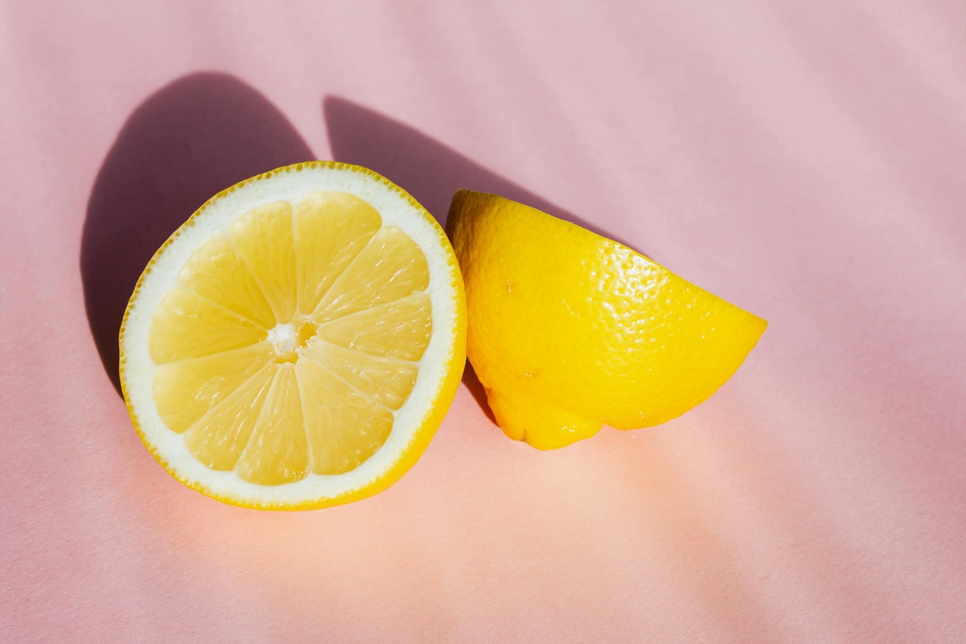 Close-up of hand holding an orange vibrator against purple backdrop
