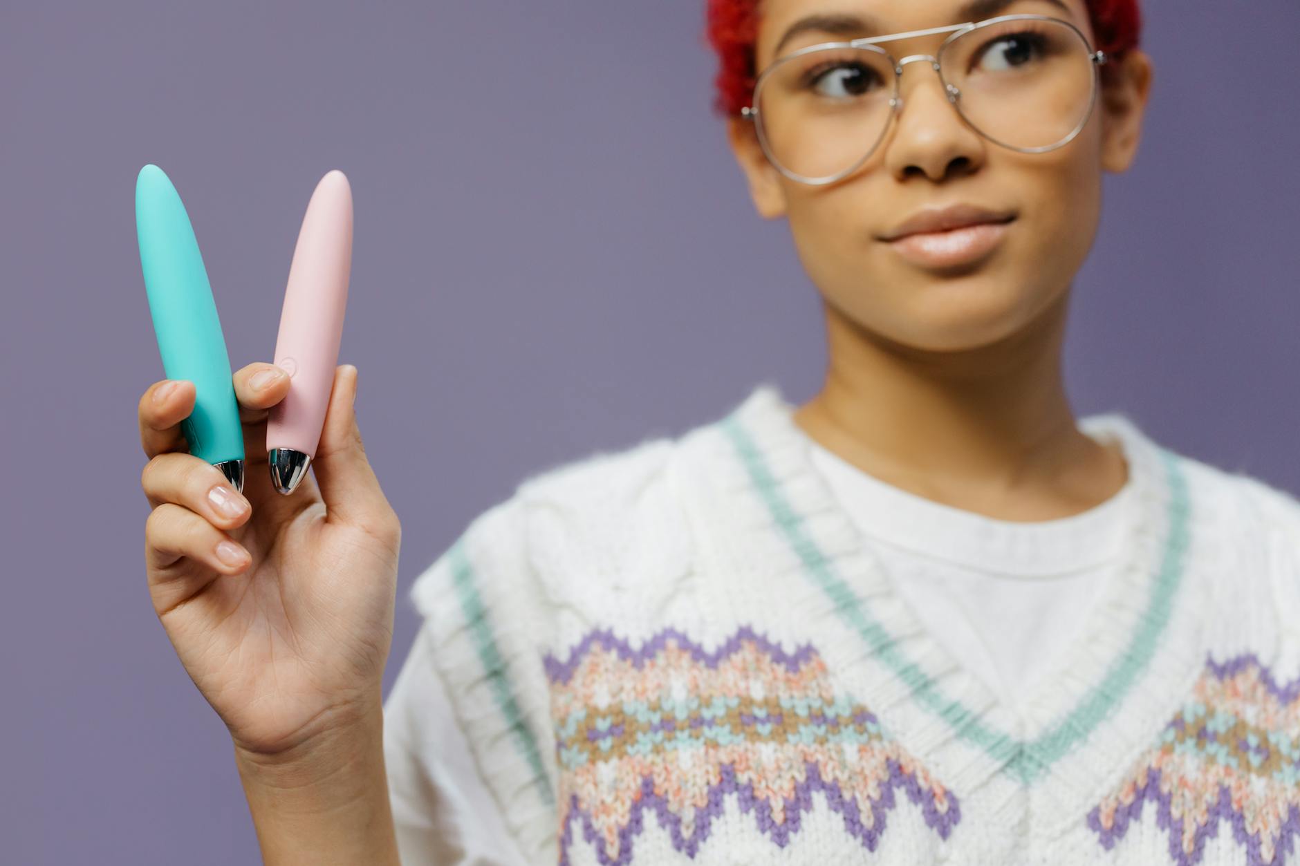 A blue silicone vibrator held confidently in hand, representing solo self-pleasure and intentional self-exploration