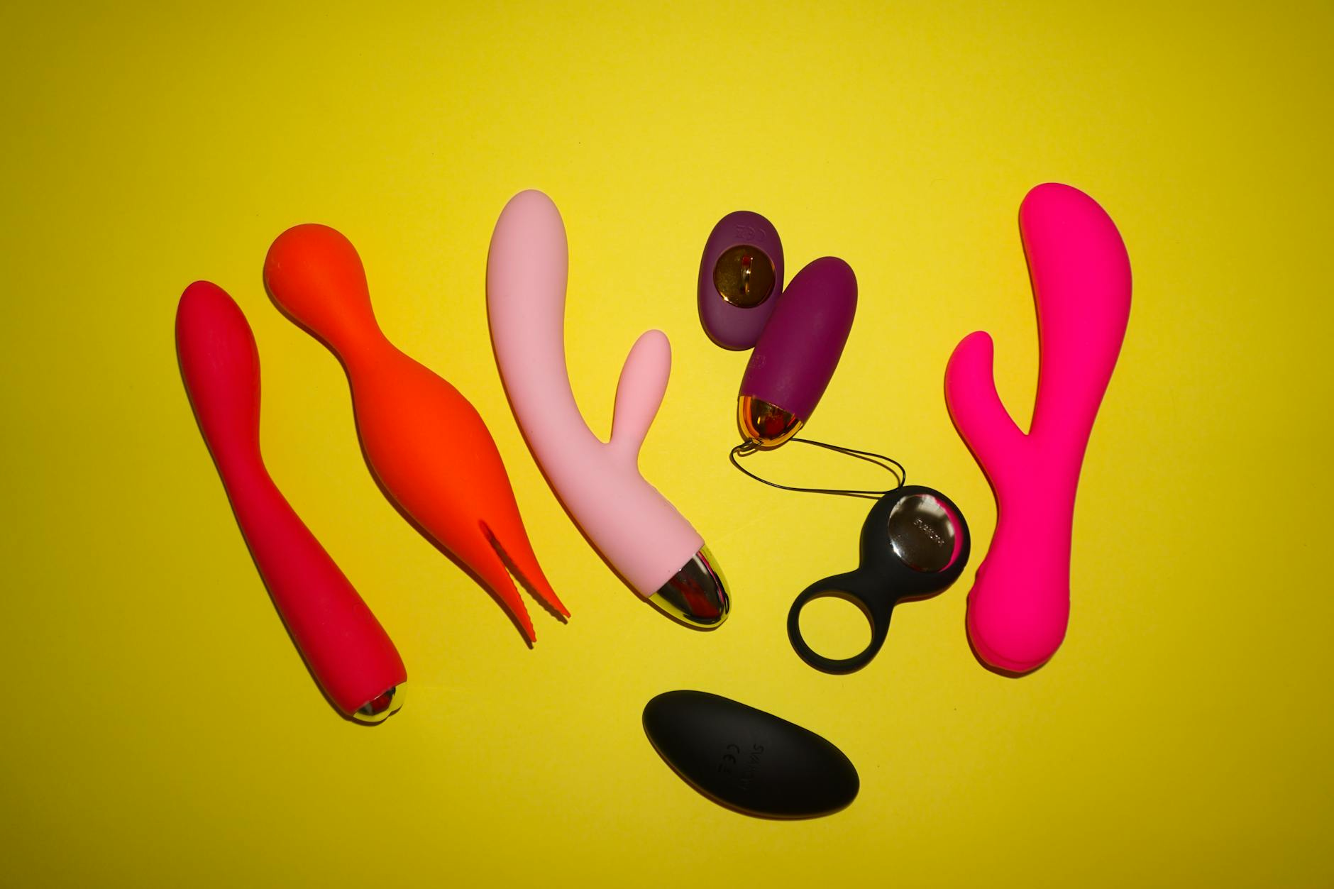 Fresh lemon held against a vibrant yellow background, symbolizing the Lemon vibrator's unique sensation profile
