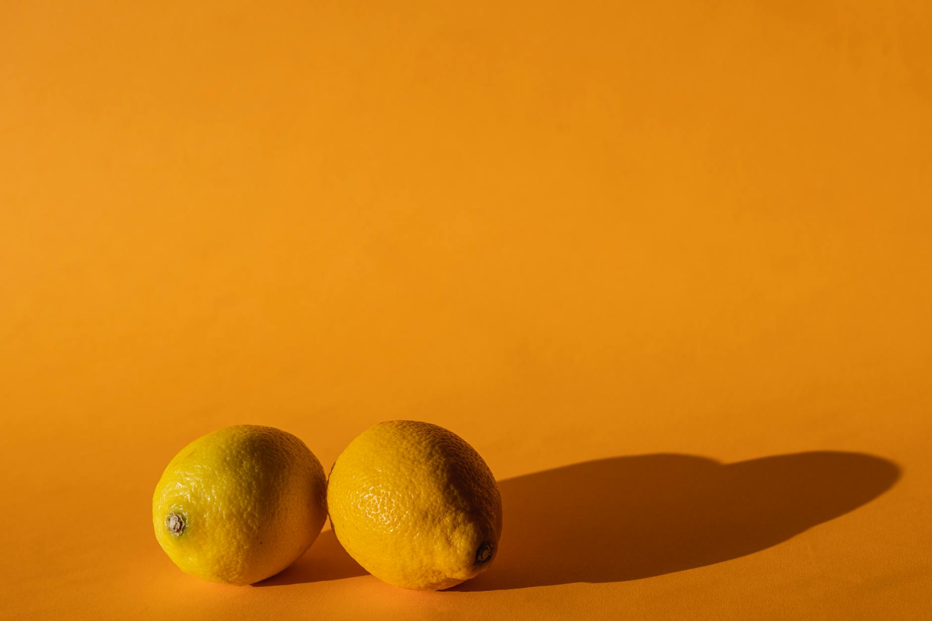 Bright ripe lemons on a yellow background symbolizing restoration and renewal